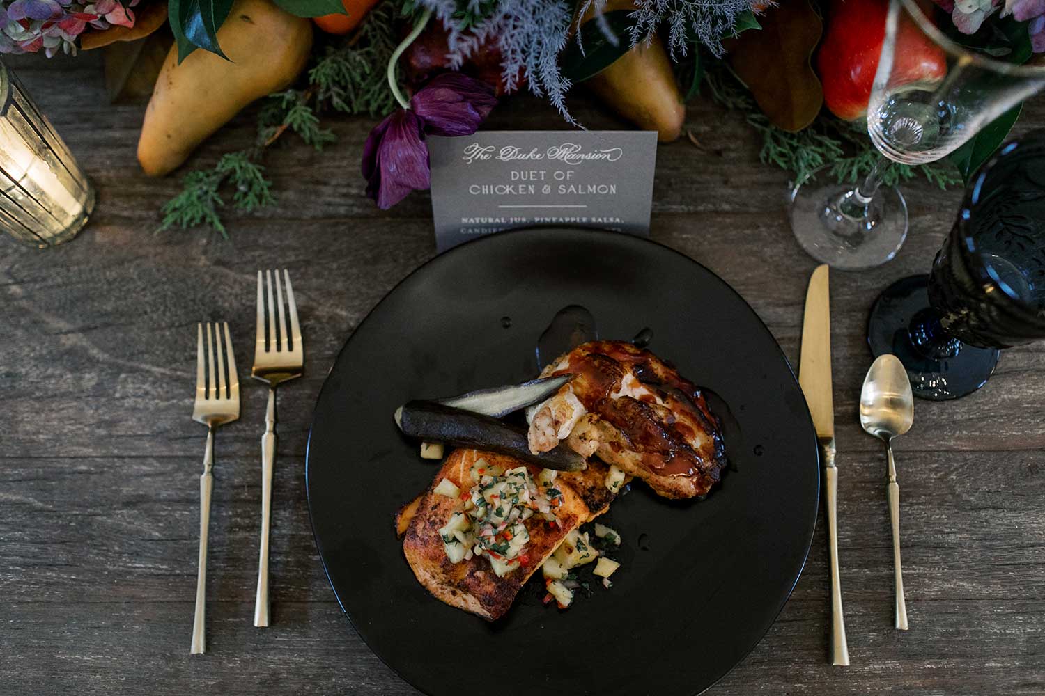 a plate of food with chicken and salmon on a table